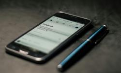 A smartphone and a pen on a desk