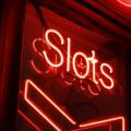 A red slots sign on the dark.