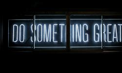 A "Do Something Great" sign in the dark