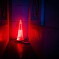 Illuminated road work cone in the dark
