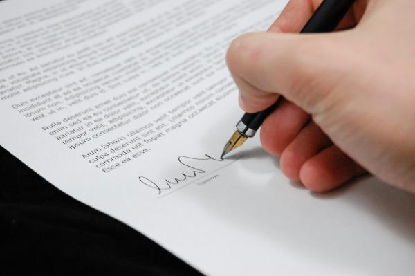 A person signing a document.