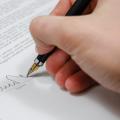 A person signing a document.