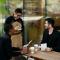 A waiter taking an order from two men