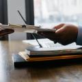 Two persons exchanging a document