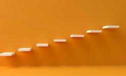 An orange wall with shelves at various level