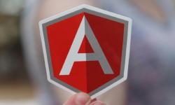 The Angular logo in the hand of someone