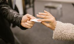 Two persons exchanging a pieace of paper