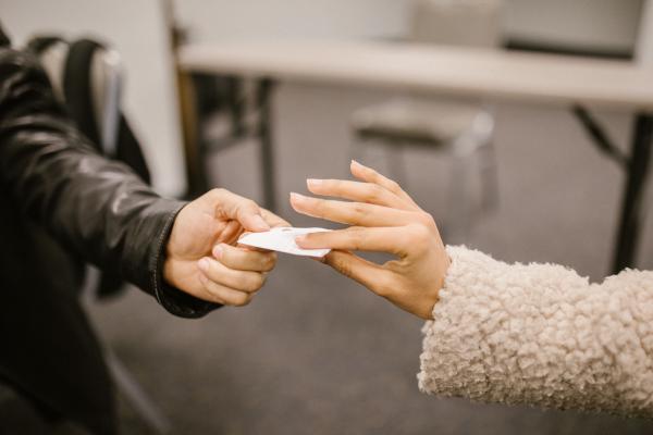 Two persons exchanging a pieace of paper