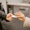 Two persons exchanging a pieace of paper