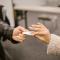 Two persons exchanging a pieace of paper