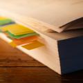 a stack of books sitting on top of a wooden table
