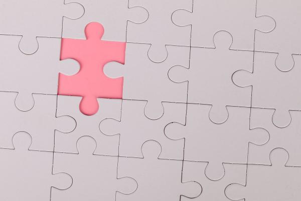 A single puzzle piece separated from the rest of the picture