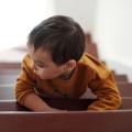 A child taking a small steps up a staircase