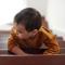 A child taking a small steps up a staircase
