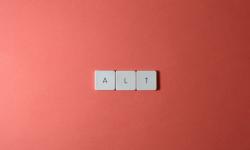 Keys A-L-T aligned on salmon-color background
